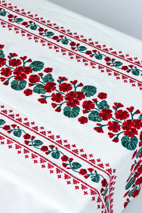 rectangular white embroidered tablecloth with red flowers