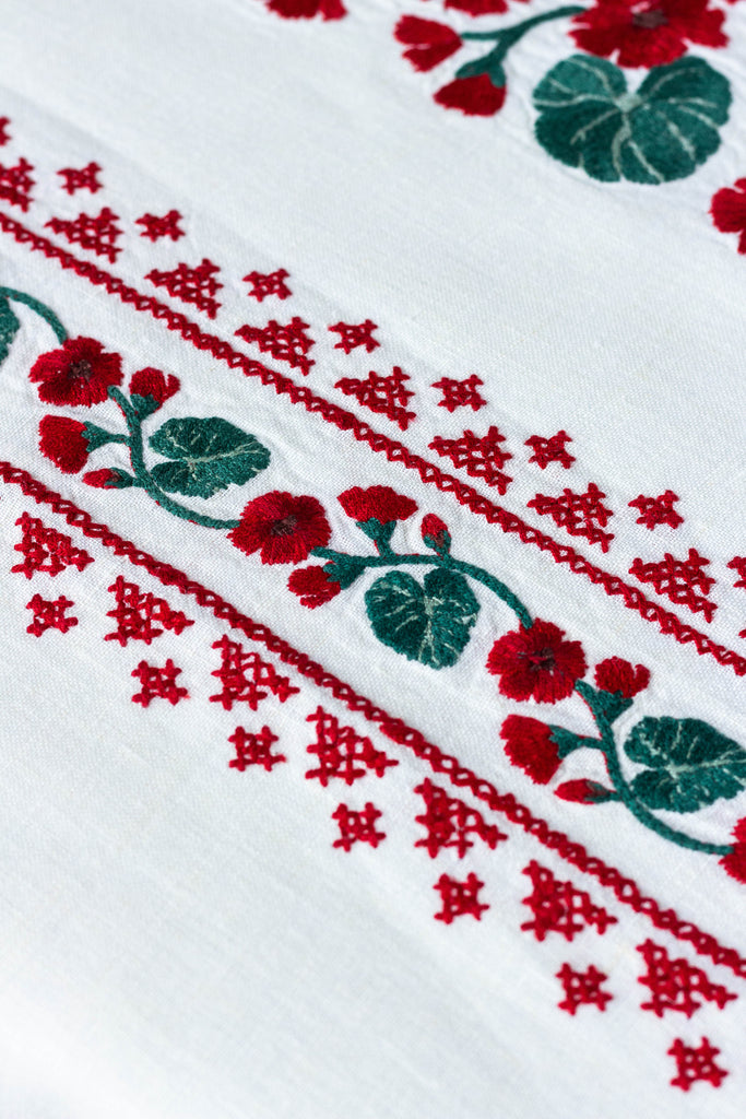 rectangular white embroidered tablecloth with red flowers detail view two