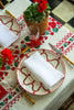 rectangular white embroidered tablecloth with red flowers with table setting