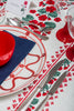 rectangular white embroidered tablecloth with red flowers with stemware