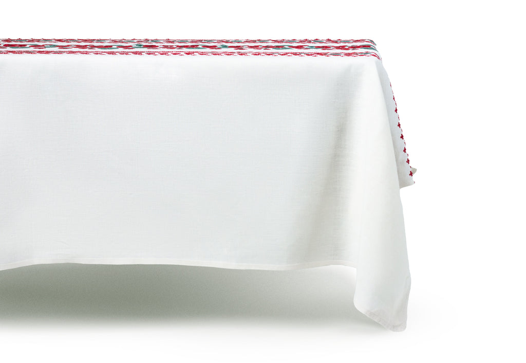 rectangular white embroidered tablecloth with red flowers distant view