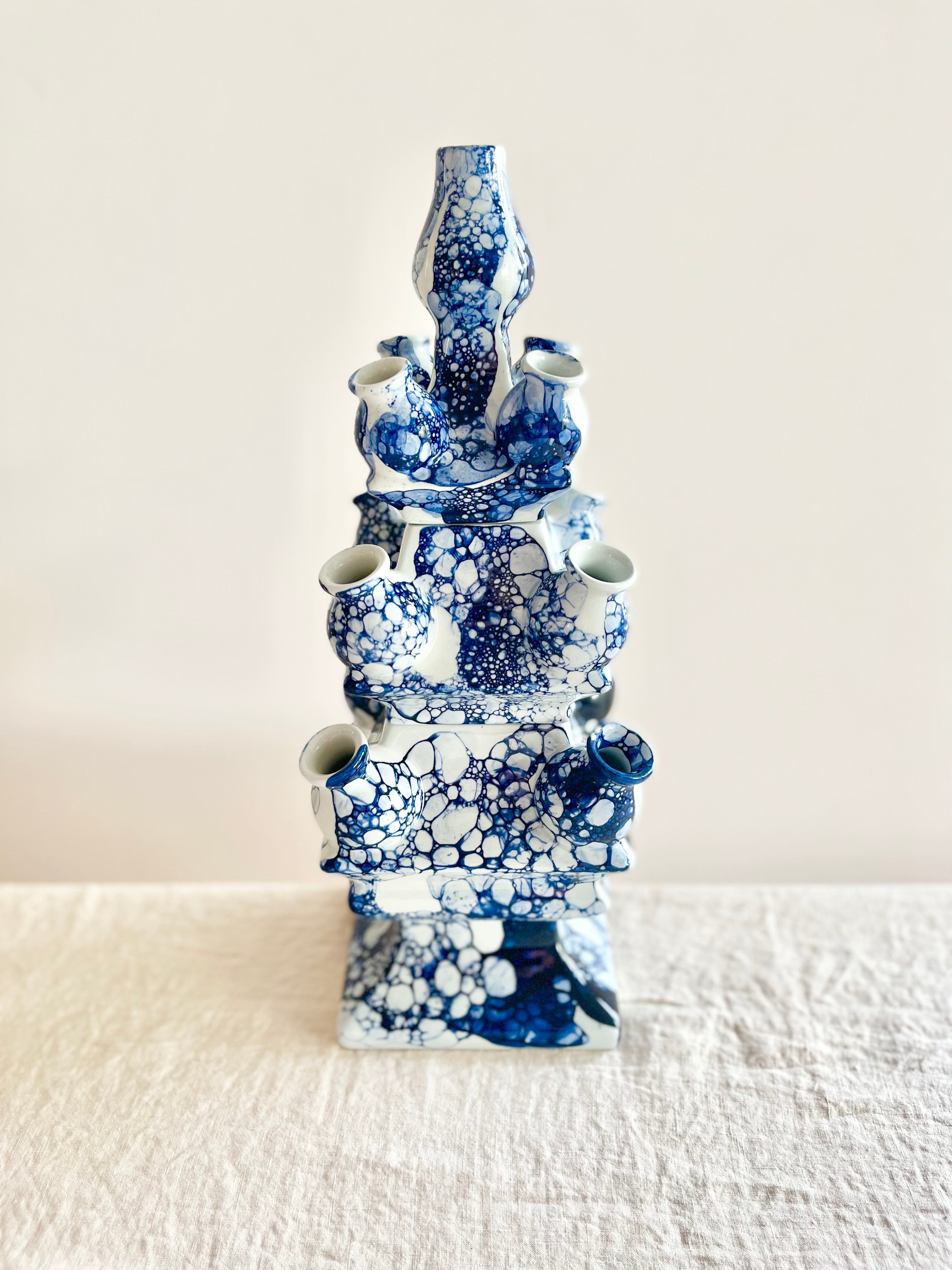 blue and white tulipiere vase on white table