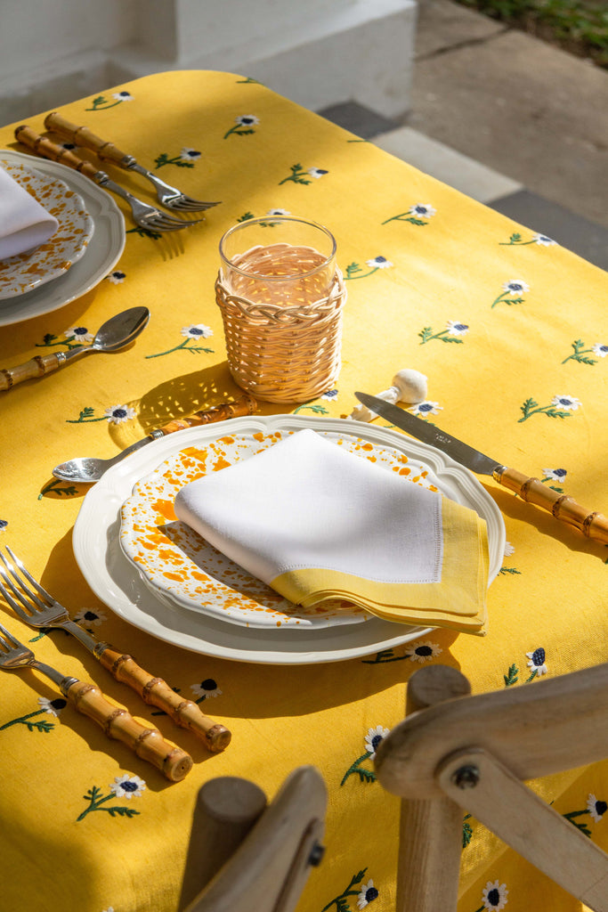 rectangular yellow tablecloth with white daisies detail view
