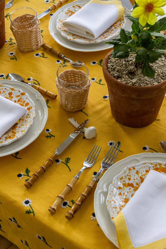 rectangular yellow tablecloth with white daisies with flower