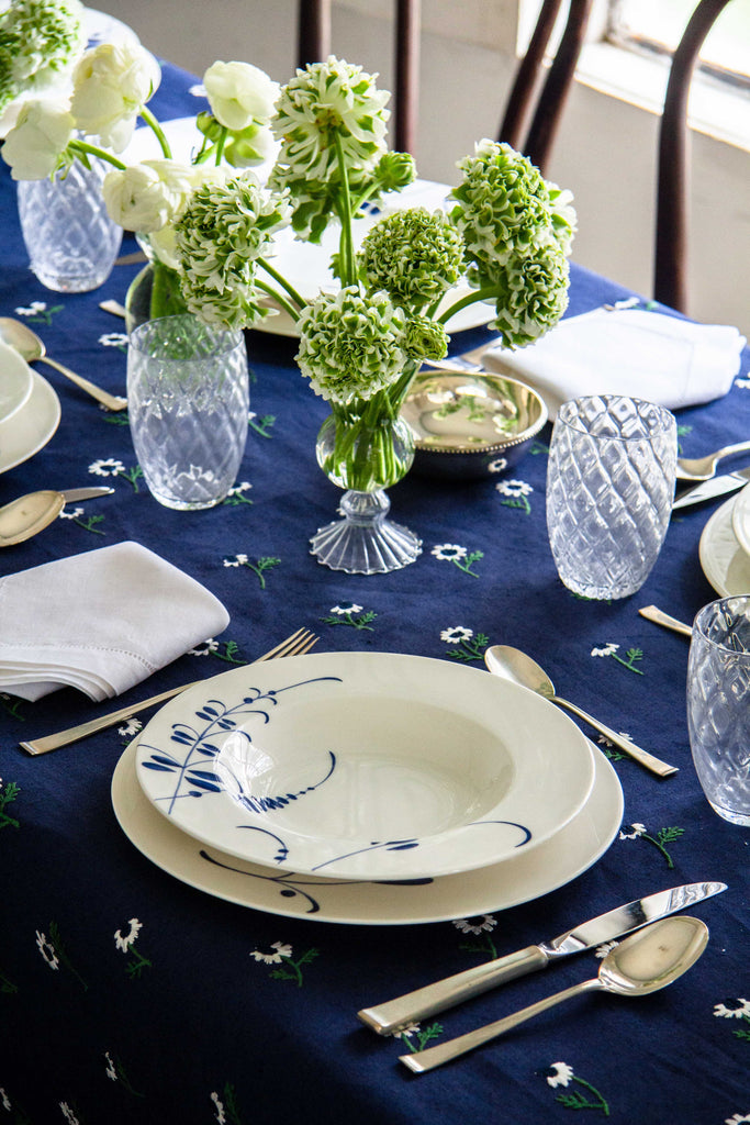 rectangular blue tablecloth with white daisies with tablesetting