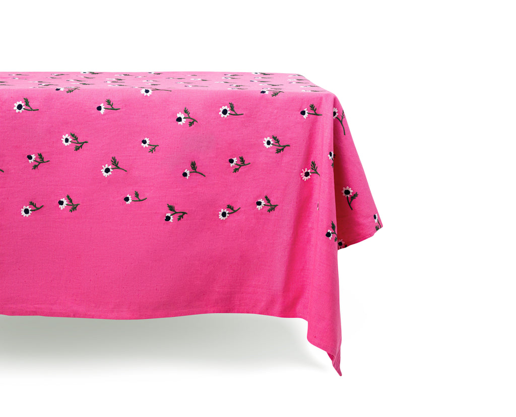 rectangular pink tablecloth with white daisies distant view