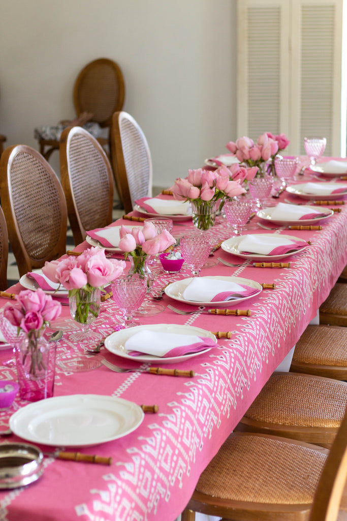 rectangular pink and white eyelet tablecloth in dining room