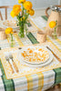 rectangular ivory and yellow embroidered placemat on plaid tablecloth