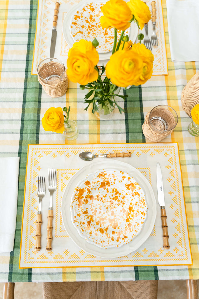 rectangular ivory and yellow embroidered placemat on table