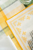 rectangular ivory and yellow embroidered placemat stitching detail