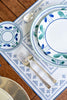 rectangular ivory and blue embroidered placemat with floral dishes