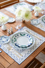 rectangular ivory and blue embroidered placemat on table