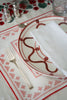 rectangular ivory and red embroidered placemat with red and white plate
