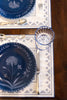 rectangular ivory and blue embroidered placemat with placesetting