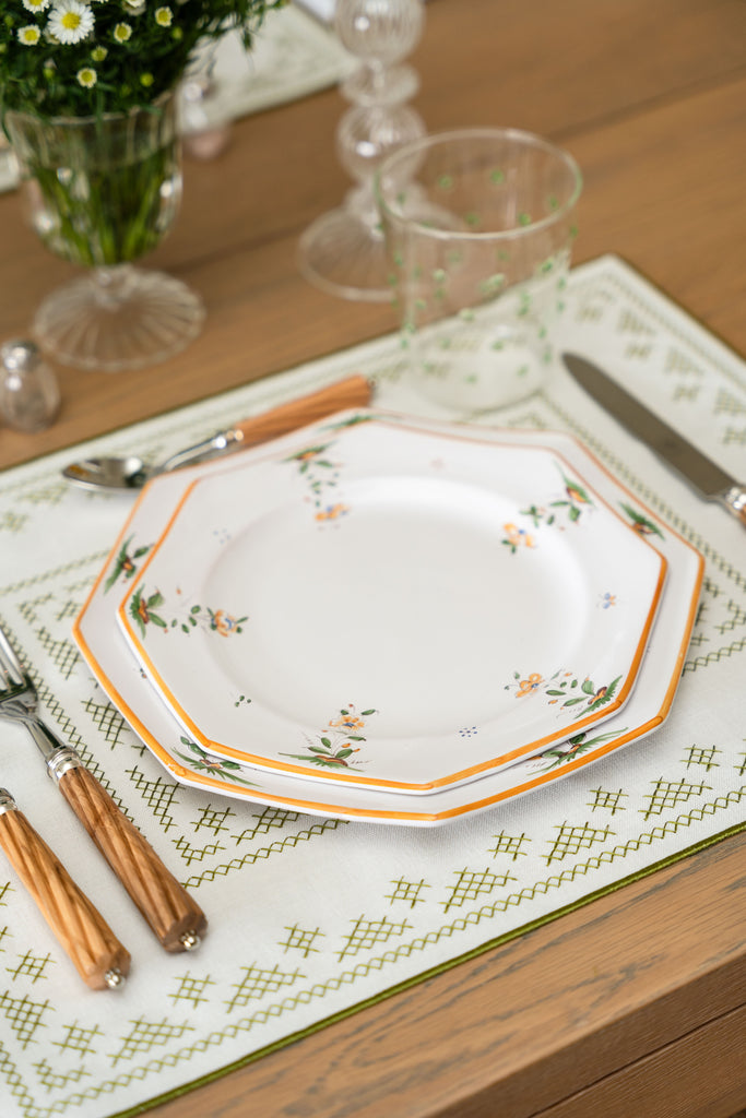 rectangular ivory and green embroidered placemat with floral plates