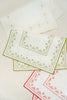rectangular ivory and green embroidered placemat folded