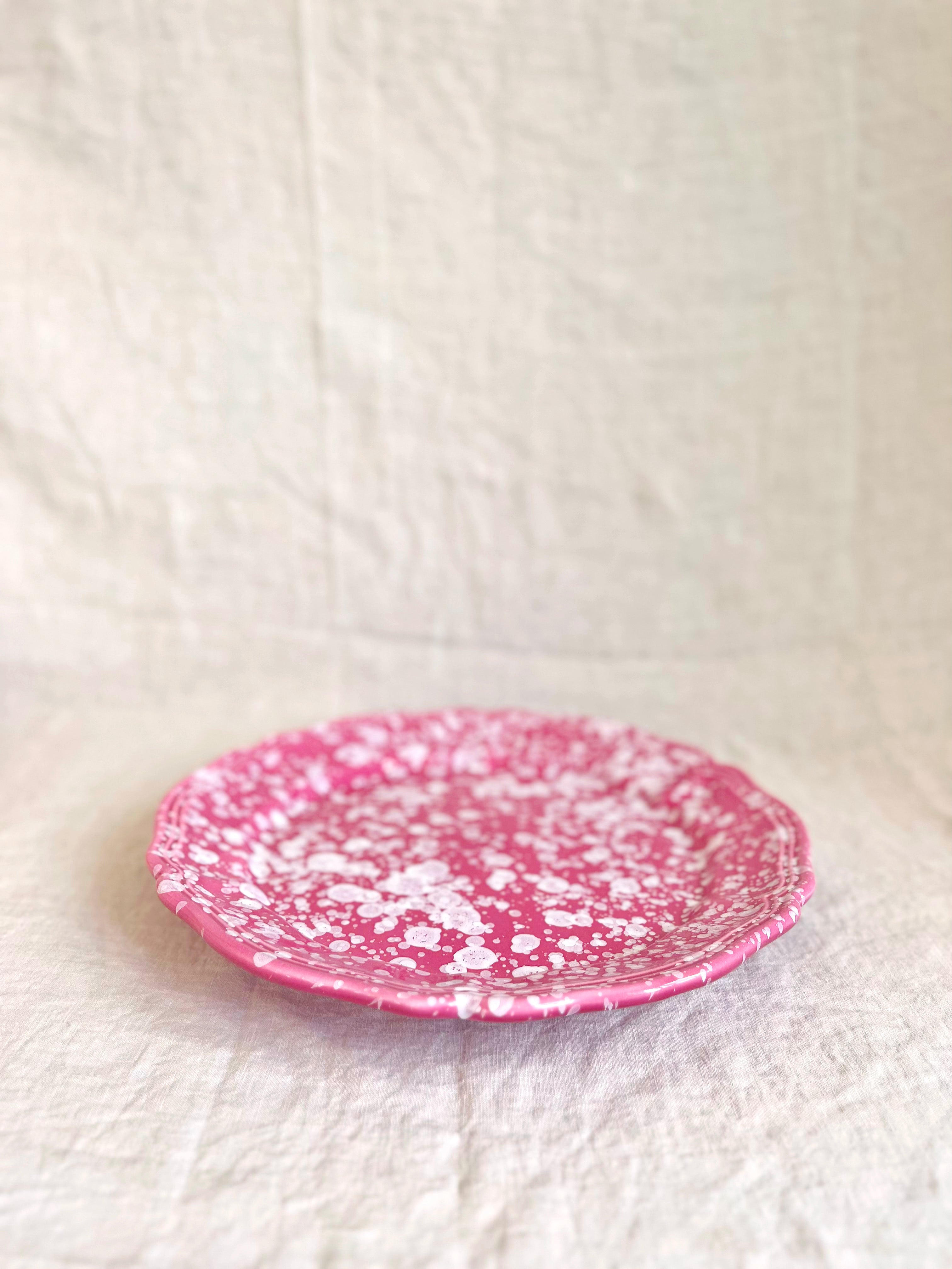 pink and white round spatterware platter 14" side view