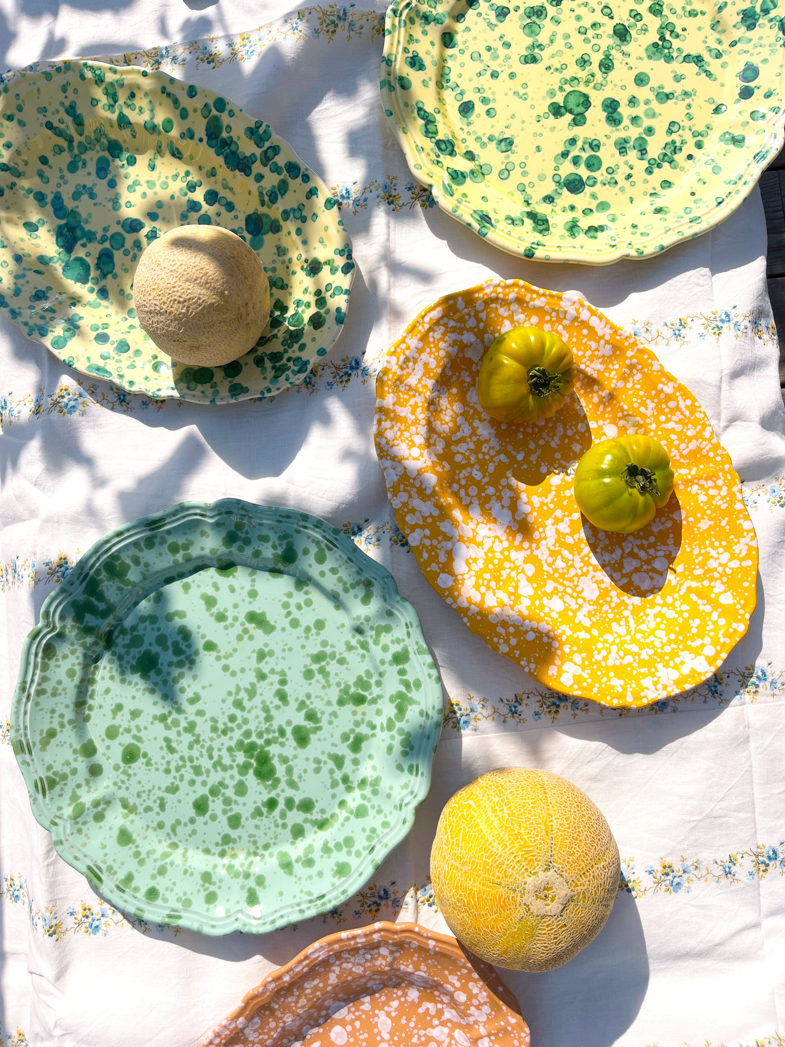 green and cream round spatterware platter in group