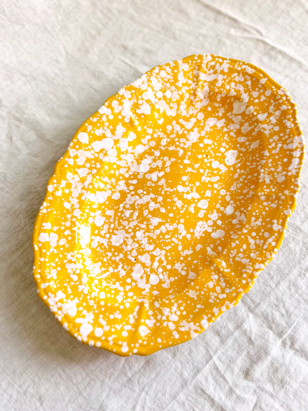 yellow and white oval spatterware platter 14" angled view