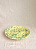 green and cream round spatterware platter side view