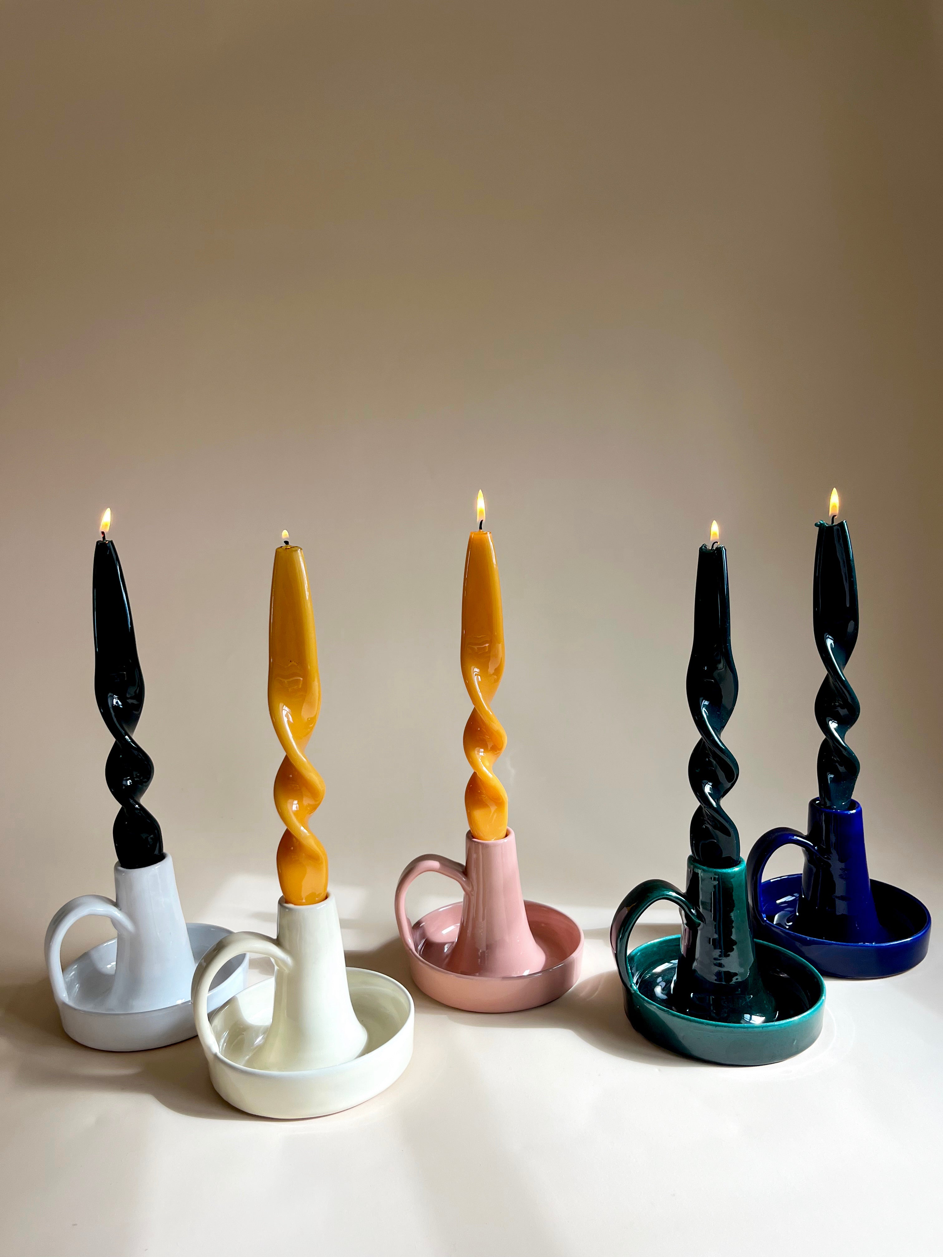 glazed ceramic taper candle holder with lit candles