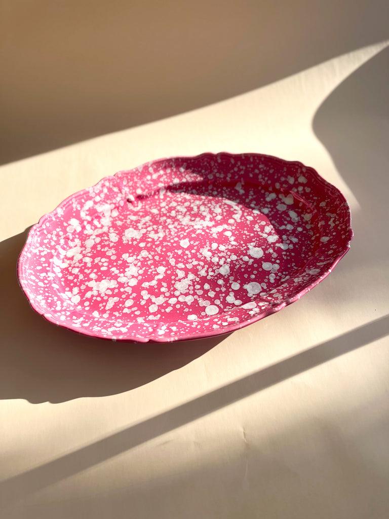 pink and white oval spatterware platter 20" on white table