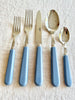 sabre stainless steel flatware set with blue resin handle on table