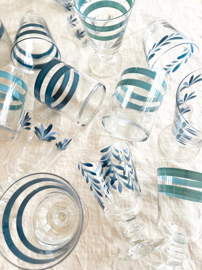 hand painted wine glasses with blue leaf pattern in group on table