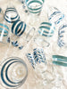water glass with blue stripes 4 inch assorted styles on a table