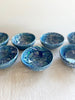 finger bowls with blue green and white swirl pattern 4 inches in diameter on white table
