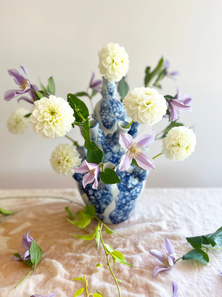 blue and white marble patterned tiered tulipiere 13 inches tall with dahlias