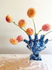 blue and white heart shaped tulipiere tower 10 inches tall with orange dahlias