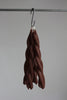twisted candles by wax atelier choco tapers hanging on hook