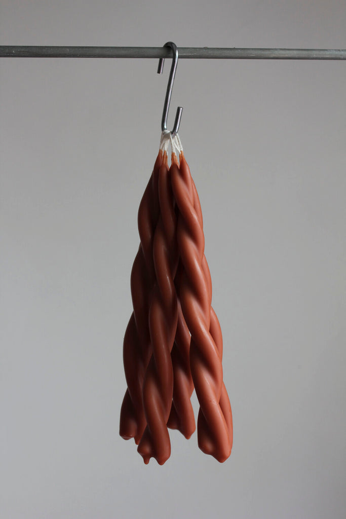 twisted candles by wax atelier tapers hanging on hook