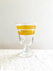 hand painted wine glass with two yellow stripes 5.5" on white table
