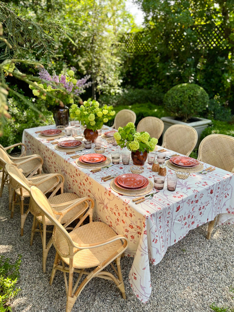 Porcelain Salad Plate shown outside on a table with rattan chairs