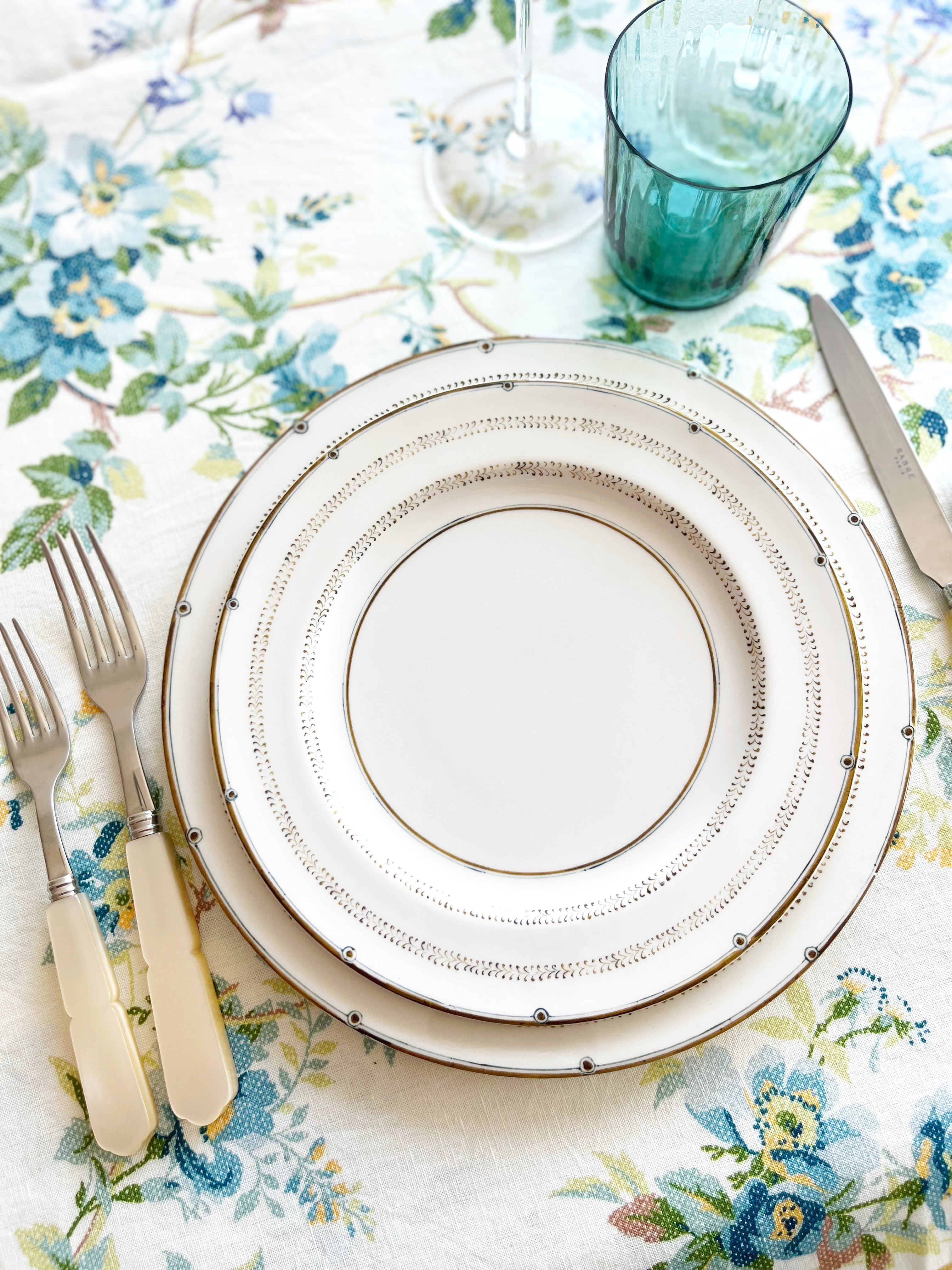 ceramic dinner plate with narrow brown brush strokes around rim with placesetting