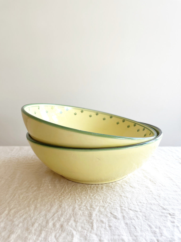 hand painted serving bowl with green rim and dots around edge stacked