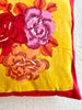 red and gold throw pillow cover with red and pink bouquet on one side 23.5 inches square detail view