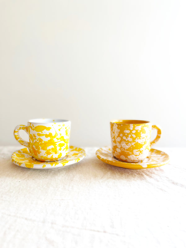 yellow fasano espresso cup with white splatter pattern on table