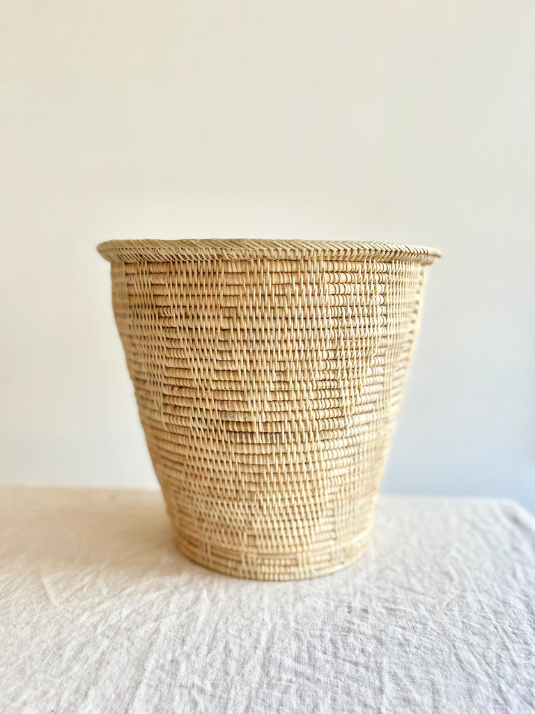 light brown hand woven wastebasket side view