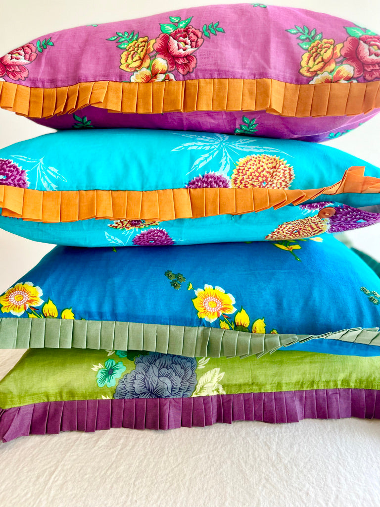 ruffle pillow covers in bright colors stacked