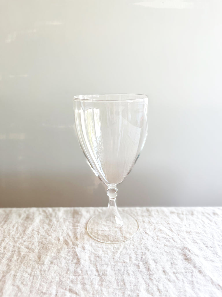 hollow stem wine glass on white table