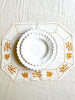 octagonal white linen placemat with gold embroidery 19.5" by 16" with placesetting