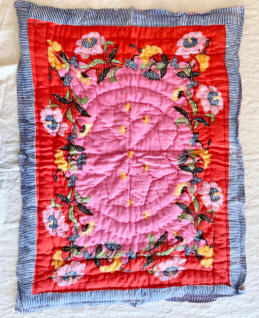 red and pink cotton quilt with pink and yellow flowers and a blue and white striped border 27 x 40 inches