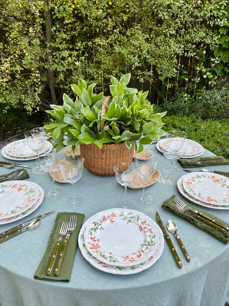 sage green linen tablecloth with macrame trim with placesetting