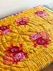 red and gold bedcover with red and pink bouquet on one side 86" by 106" as tablecloth