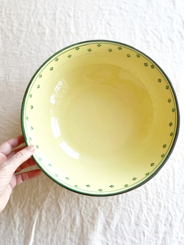 hand painted serving bowl with green rim and dots around edge top view