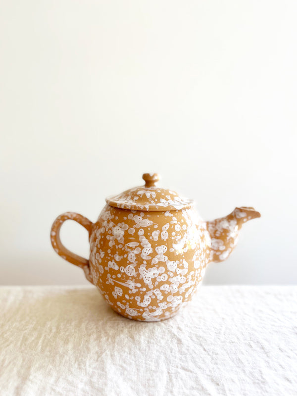 teapot with splatter pattern in sienna color side view