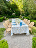 white tablecloth with blue and brown floral pattern on table outside